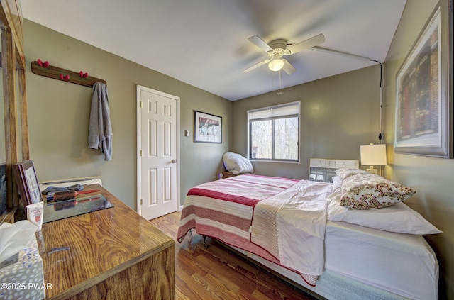 bedroom with a ceiling fan and wood finished floors