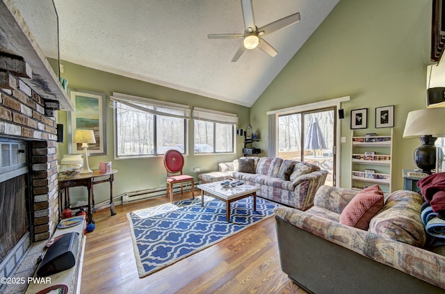 living room with high vaulted ceiling, wood finished floors, a baseboard heating unit, ceiling fan, and a brick fireplace