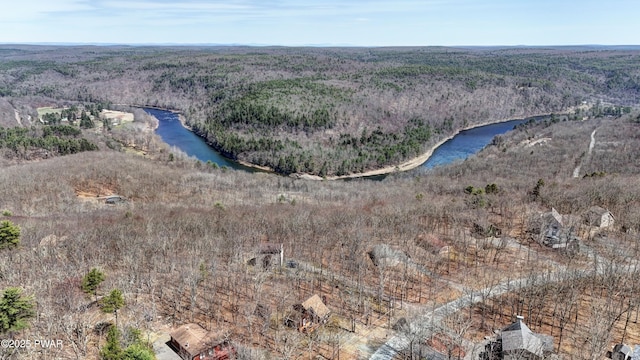 aerial view with a forest view and a water view