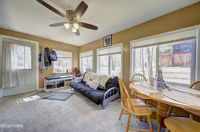 living room featuring baseboards, a ceiling fan, and carpet flooring