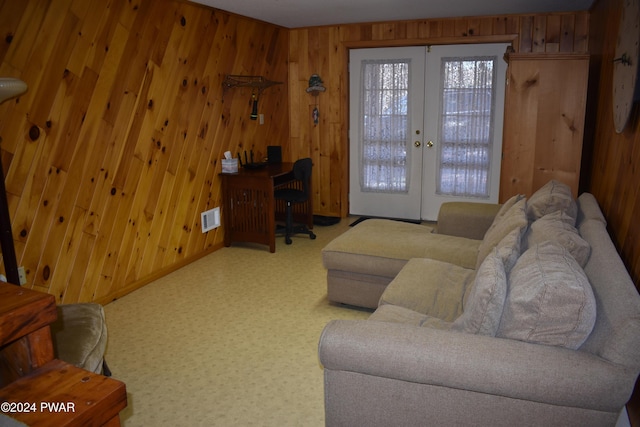 living room with wooden walls and french doors