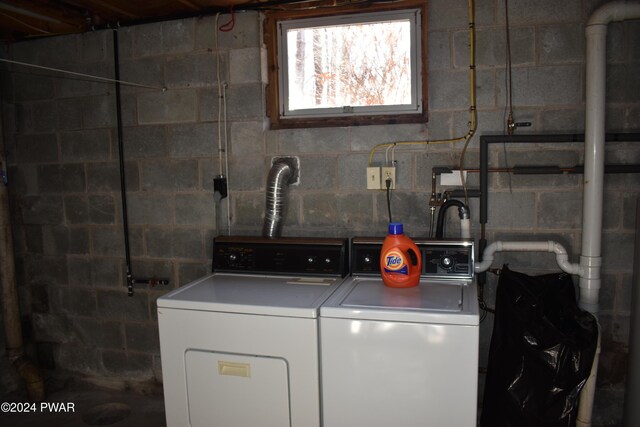 clothes washing area featuring washer and dryer