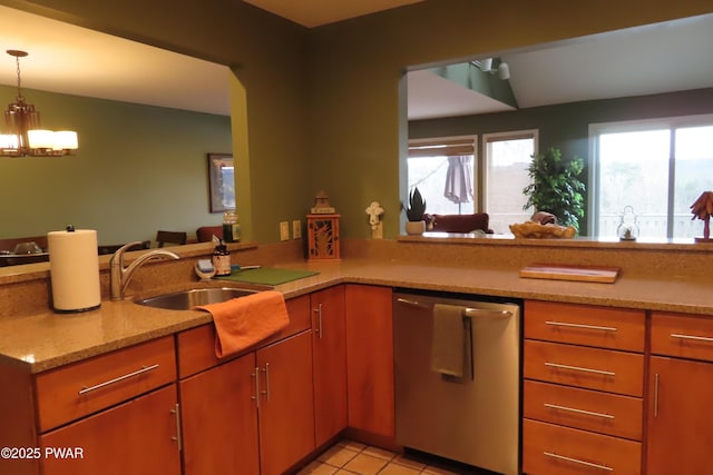 kitchen with light tile patterned floors, a peninsula, a sink, hanging light fixtures, and stainless steel dishwasher