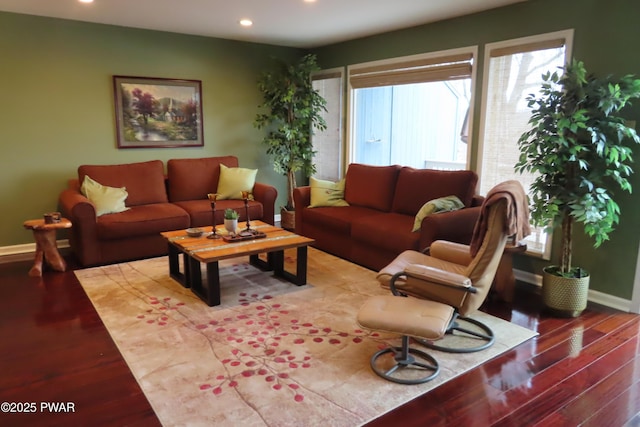 living room featuring baseboards, wood finished floors, and recessed lighting