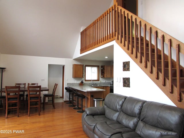 169 N Lake Dr, Dingmans Ferry, PA 18328 - living area featuring high vaulted ceiling, light wood-type flooring, and stairs