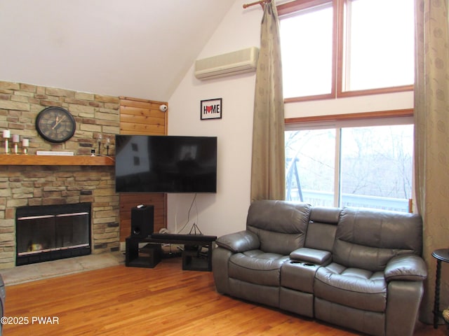 169 N Lake Dr, Dingmans Ferry, PA 18328 - living area with a wall mounted AC, wood finished floors, a fireplace, and lofted ceiling