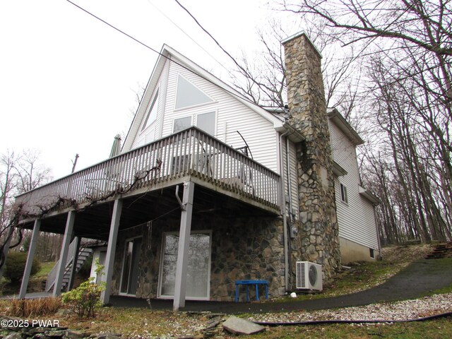 169 N Lake Dr, Dingmans Ferry, PA 18328 - rear view of house featuring stairway, a deck, a chimney, and ac unit