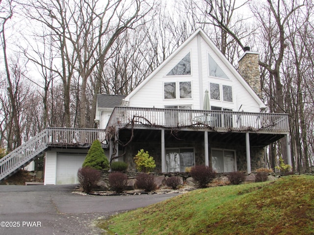169 N Lake Dr, Dingmans Ferry, PA 18328 - chalet / cabin featuring a chimney, aphalt driveway, and a deck