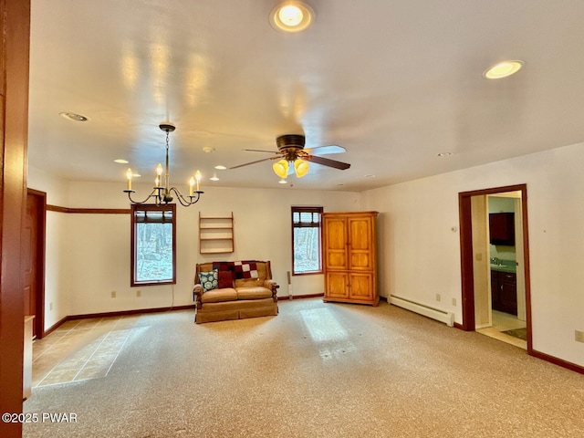 unfurnished room with a baseboard radiator, ceiling fan with notable chandelier, and light carpet