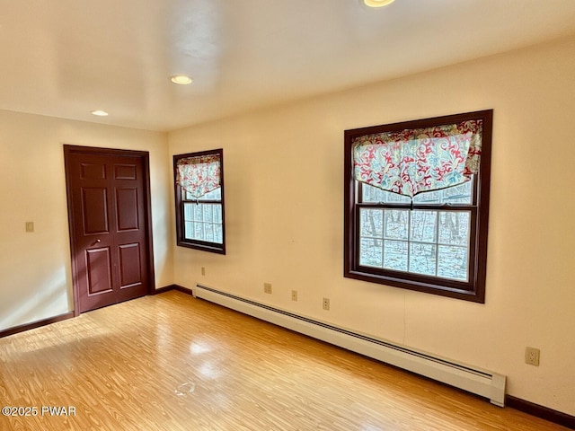 interior space with a baseboard radiator and light wood-type flooring