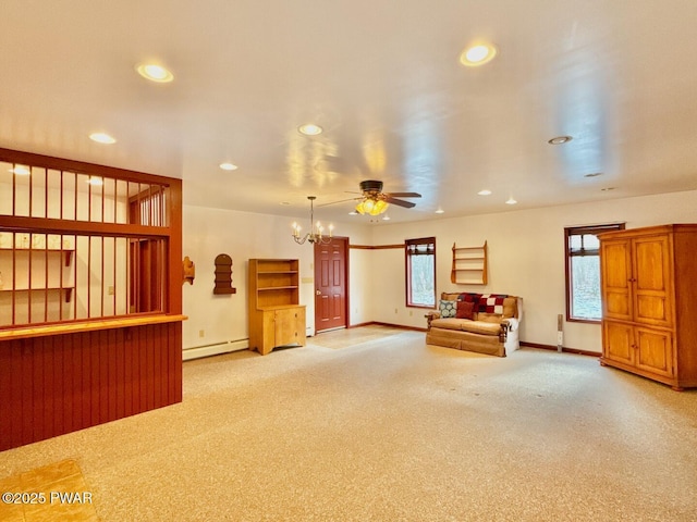 interior space featuring a baseboard radiator, ceiling fan with notable chandelier, and light carpet