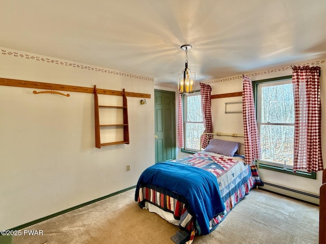 carpeted bedroom featuring a baseboard heating unit