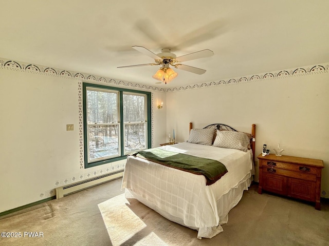 carpeted bedroom featuring a baseboard heating unit and ceiling fan