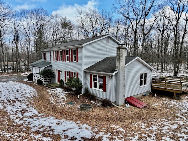 view of snowy exterior with a deck