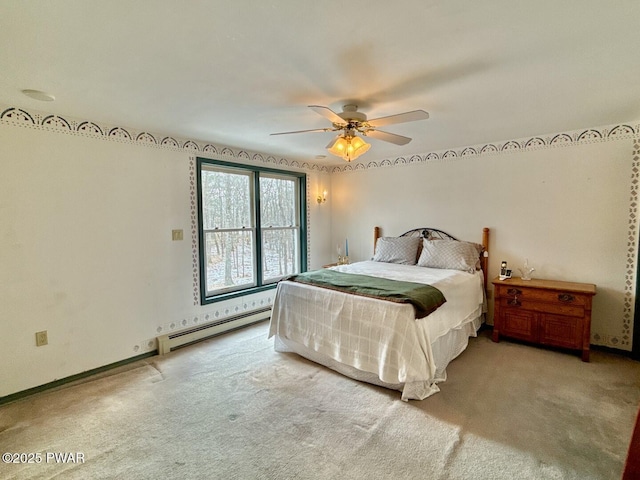 carpeted bedroom featuring a baseboard radiator and ceiling fan