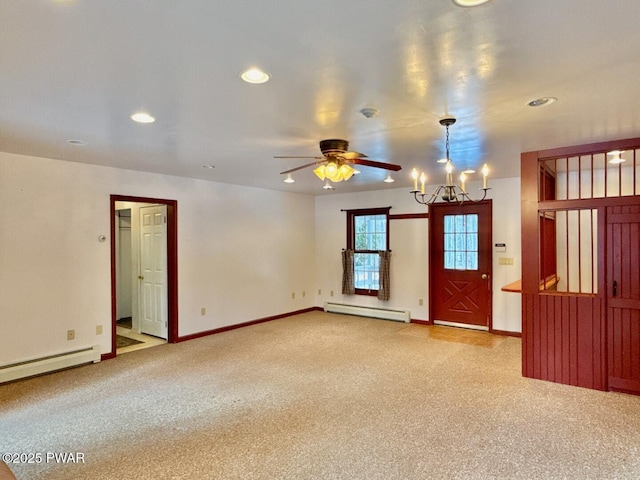 empty room featuring ceiling fan with notable chandelier, light carpet, and a baseboard heating unit