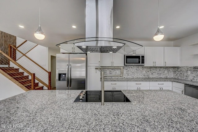 kitchen featuring appliances with stainless steel finishes, decorative light fixtures, white cabinets, island exhaust hood, and light stone counters