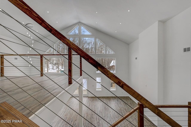 unfurnished living room featuring lofted ceiling