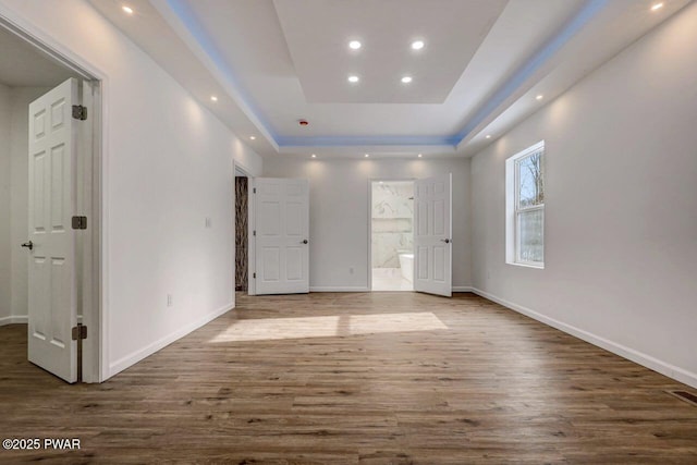 interior space featuring dark hardwood / wood-style floors and a raised ceiling