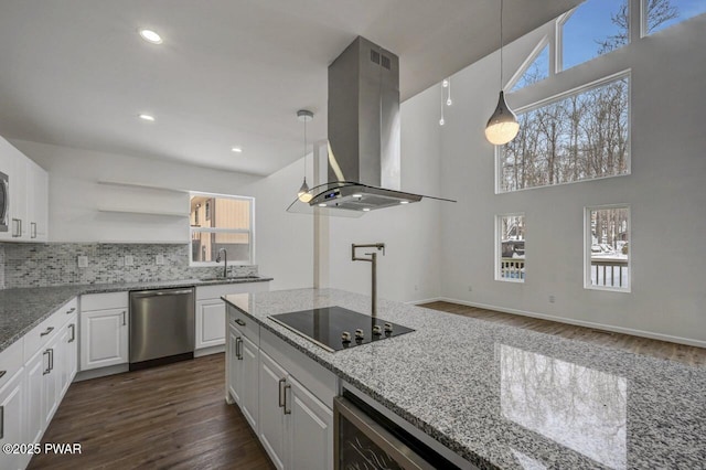 kitchen with decorative light fixtures, black electric cooktop, dishwasher, island exhaust hood, and white cabinets