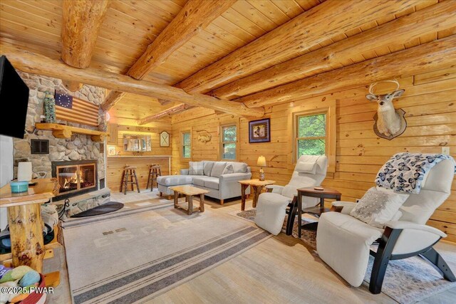 210 Fawn Lake Dr, Hawley, PA 18428 - living room with wood finished floors, wooden walls, a wood ceiling with exposed beams, and a stone fireplace