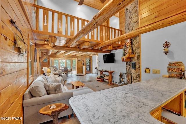 210 Fawn Lake Dr, Hawley, PA 18428 - living room with beamed ceiling, wood finished floors, and a high ceiling