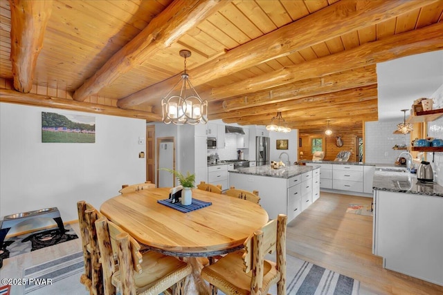 210 Fawn Lake Dr, Hawley, PA 18428 - dining area featuring a chandelier, light wood-style floors, and a wooden ceiling with exposed beams