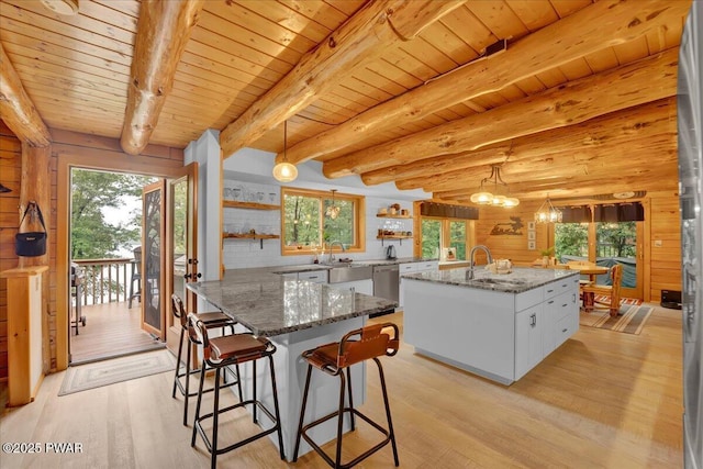 210 Fawn Lake Dr, Hawley, PA 18428 - kitchen with open shelves, light wood-style floors, healthy amount of natural light, a wood ceiling with exposed beams, and wooden walls