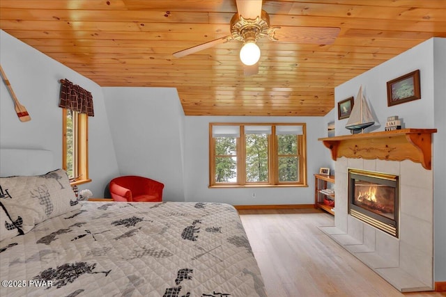 210 Fawn Lake Dr, Hawley, PA 18428 - bedroom featuring wooden ceiling, wood finished floors, a tile fireplace, and ceiling fan