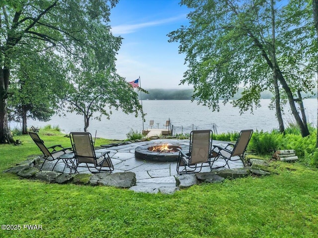 210 Fawn Lake Dr, Hawley, PA 18428 - view of grassy yard with an outdoor fire pit, a water view, and a patio area