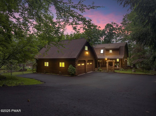 210 Fawn Lake Dr, Hawley, PA 18428 - cabin with asphalt driveway, log siding, and covered porch