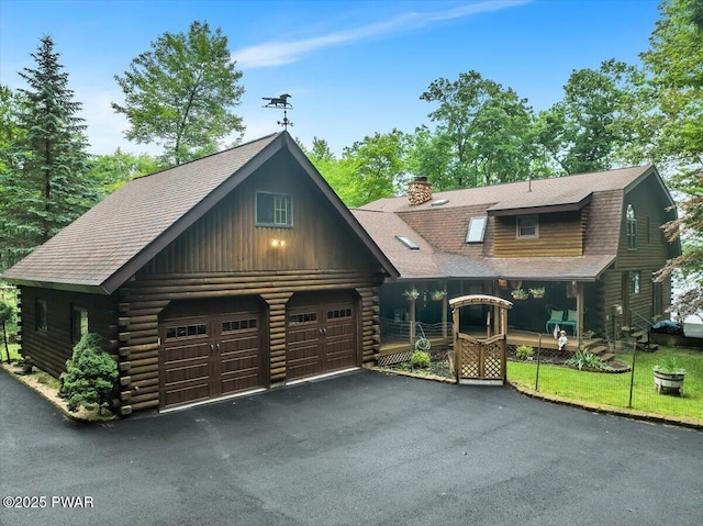 210 Fawn Lake Dr, Hawley, PA 18428 - log-style house featuring log exterior, a shingled roof, a chimney, and a garage