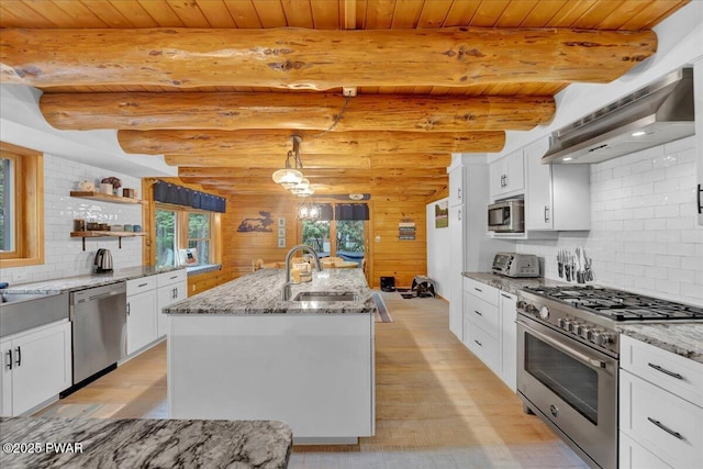 210 Fawn Lake Dr, Hawley, PA 18428 - kitchen with appliances with stainless steel finishes, wall chimney range hood, light wood-style flooring, tasteful backsplash, and white cabinets