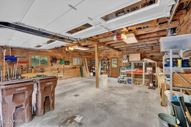 210 Fawn Lake Dr, Hawley, PA 18428 - garage with wooden walls, a workshop area, and a garage door opener