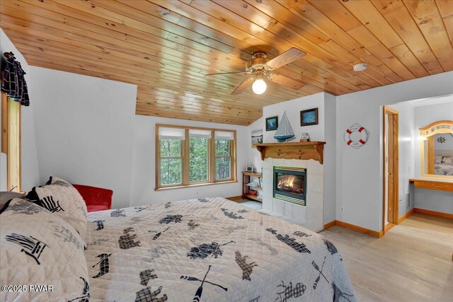 210 Fawn Lake Dr, Hawley, PA 18428 - bedroom with wooden ceiling, wood finished floors, a tile fireplace, lofted ceiling, and ceiling fan