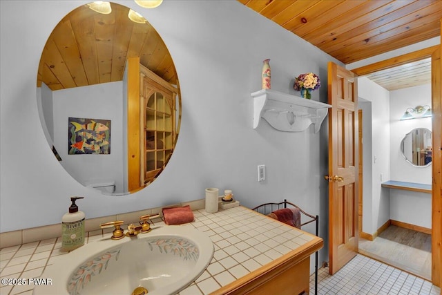 210 Fawn Lake Dr, Hawley, PA 18428 - bathroom featuring wooden ceiling, tile patterned flooring, and vanity