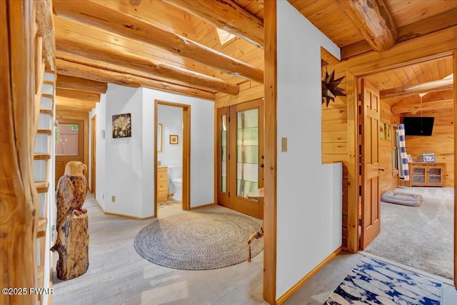210 Fawn Lake Dr, Hawley, PA 18428 - entryway with a wooden ceiling with exposed beams, wood walls, and wood finished floors