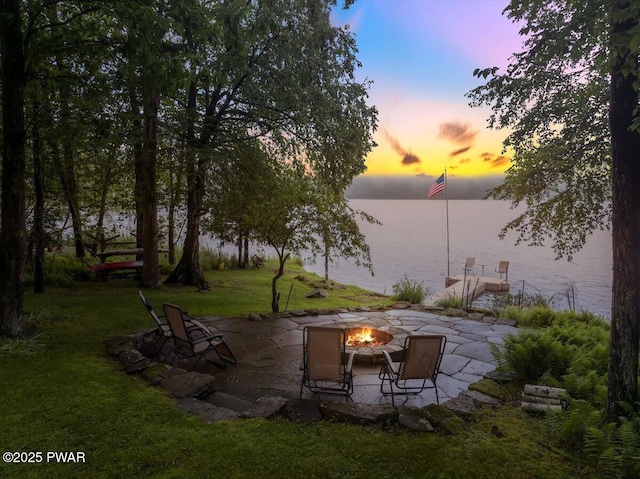 210 Fawn Lake Dr, Hawley, PA 18428 - patio terrace at dusk featuring an outdoor fire pit, a water view, a patio, and a yard