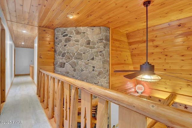 210 Fawn Lake Dr, Hawley, PA 18428 - hallway with wood ceiling, wood finished floors, wood walls, and an upstairs landing