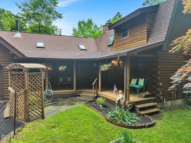 210 Fawn Lake Dr, Hawley, PA 18428 - back of property with roof with shingles, a wooden deck, log exterior, a yard, and a chimney