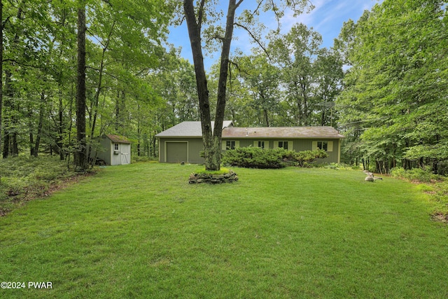 view of front of property with a front yard and a storage shed