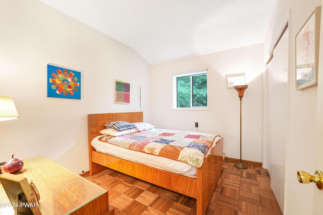 bedroom featuring parquet floors and lofted ceiling