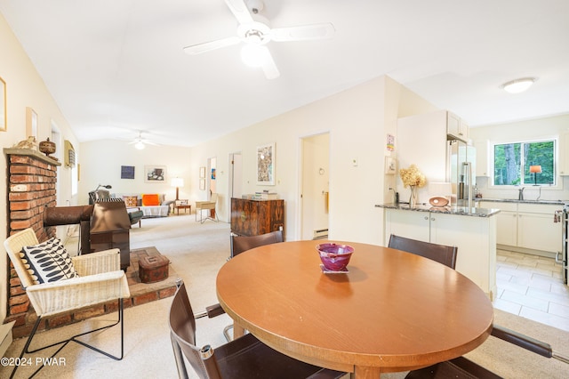 dining area with ceiling fan, lofted ceiling, and baseboard heating