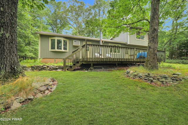 rear view of house with a yard and a deck