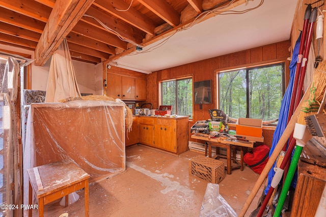 miscellaneous room with a workshop area and wood walls