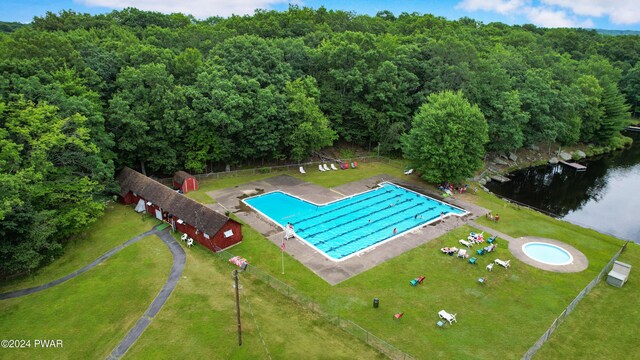 view of swimming pool with a water view