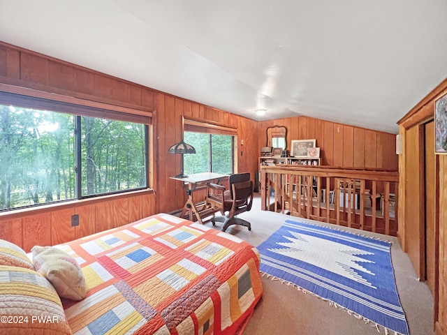 carpeted bedroom with wooden walls and lofted ceiling