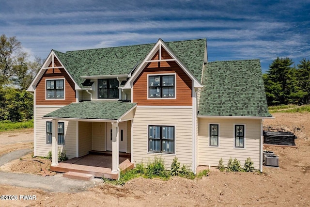 8 Matthews Dr, Milford, PA 18337 - view of front facade featuring roof with shingles, cooling unit, and a porch