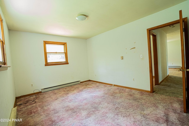 unfurnished room with carpet and a baseboard radiator