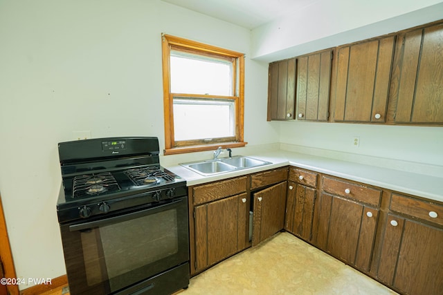 kitchen featuring gas stove and sink